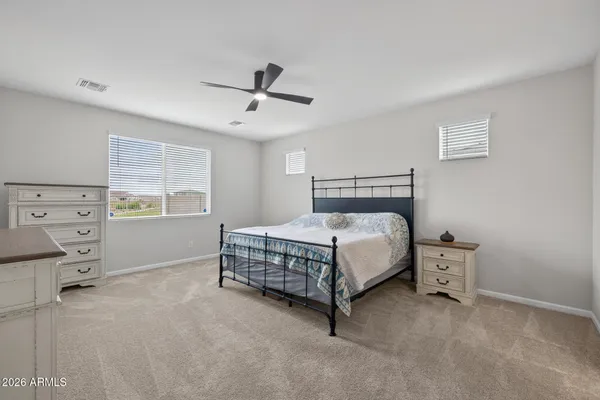 a bedroom with a bed and a chair in it