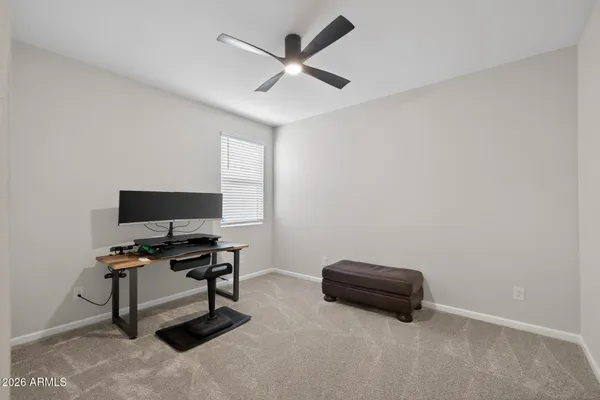 a living room with furniture and a ceiling fan