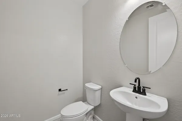 a bathroom with a sink a mirror and a toilet