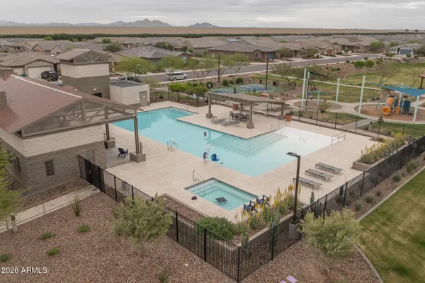 an aerial view of residential houses with outdoor space and ocean view