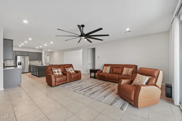 a living room with furniture and a ceiling fan