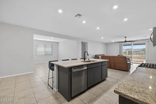 a kitchen with stainless steel appliances granite countertop a sink and a stove