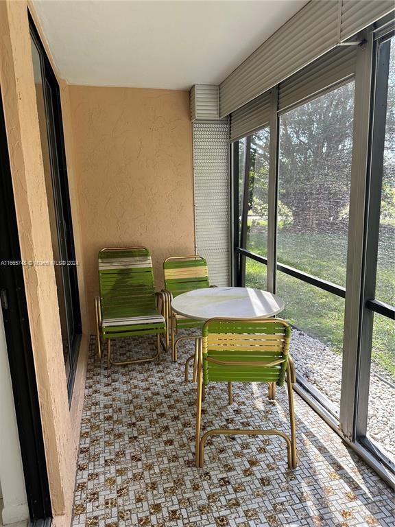 7950 West McNab Road, Unit 106 Tamarac, FL 33321 - Photo 15 of 33 a view of a room with a table and chairs