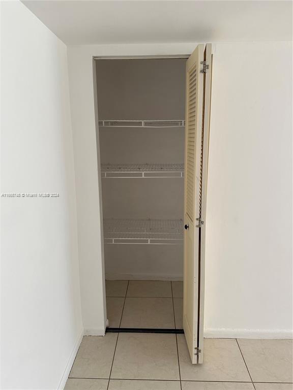 7950 West McNab Road, Unit 106 Tamarac, FL 33321 - Photo 19 of 33 a view of walk in closet with empty racks