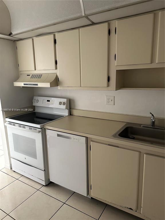7950 West McNab Road, Unit 106 Tamarac, FL 33321 - Photo 22 of 33 a kitchen with a sink cabinets and appliances