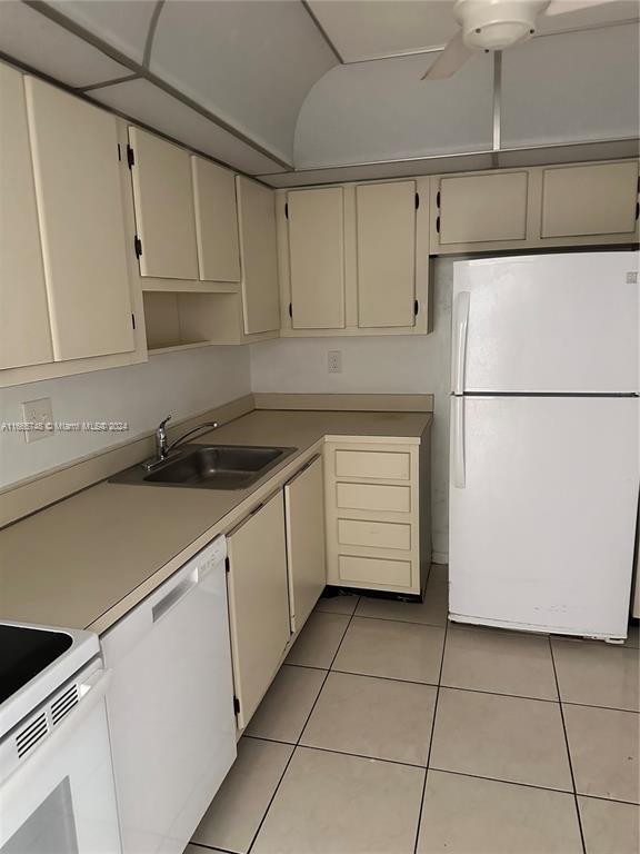 7950 West McNab Road, Unit 106 Tamarac, FL 33321 - Photo 23 of 33 a kitchen with a white cabinets and white appliances