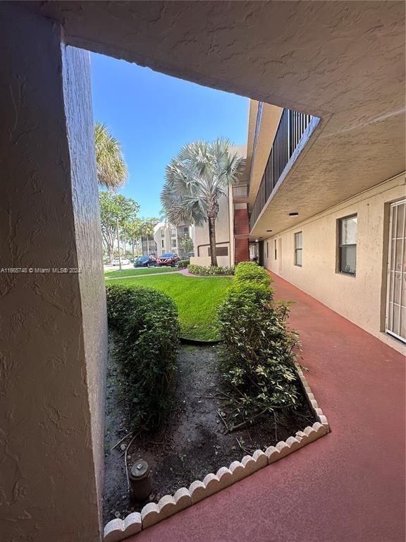 7950 West McNab Road, Unit 106 Tamarac, FL 33321 - Photo 3 of 33 front view of a house with a yard