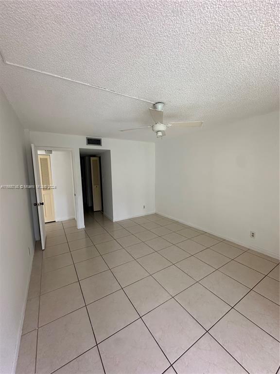 7950 West McNab Road, Unit 106 Tamarac, FL 33321 - Photo 6 of 33 a view of a livingroom with an empty space and a sink