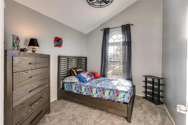 a bedroom with a bed and a dresser in it