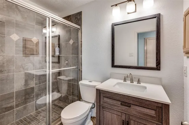 a bathroom with a sink toilet and shower