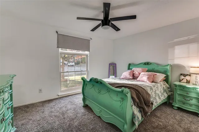 a bed sitting in a bedroom next to a window