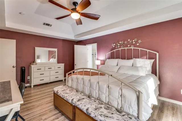 a bed room with a bed and a chair