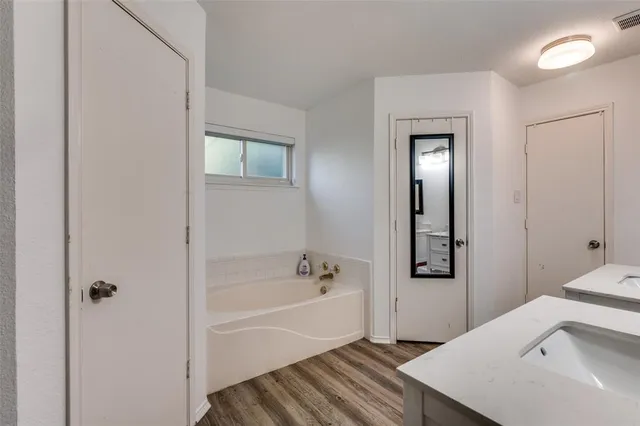 a bathroom with a bathtub and a sink