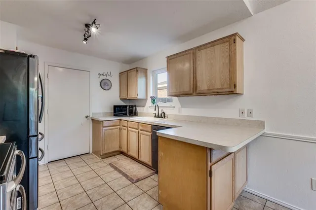 a kitchen with a sink cabinets and stainless steel appliances