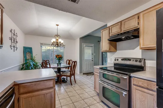 a view of a dining room with furniture and chandelier