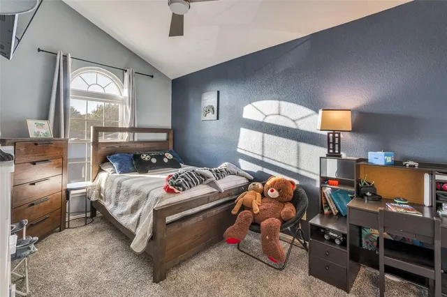 a bedroom with a bed and a mirror