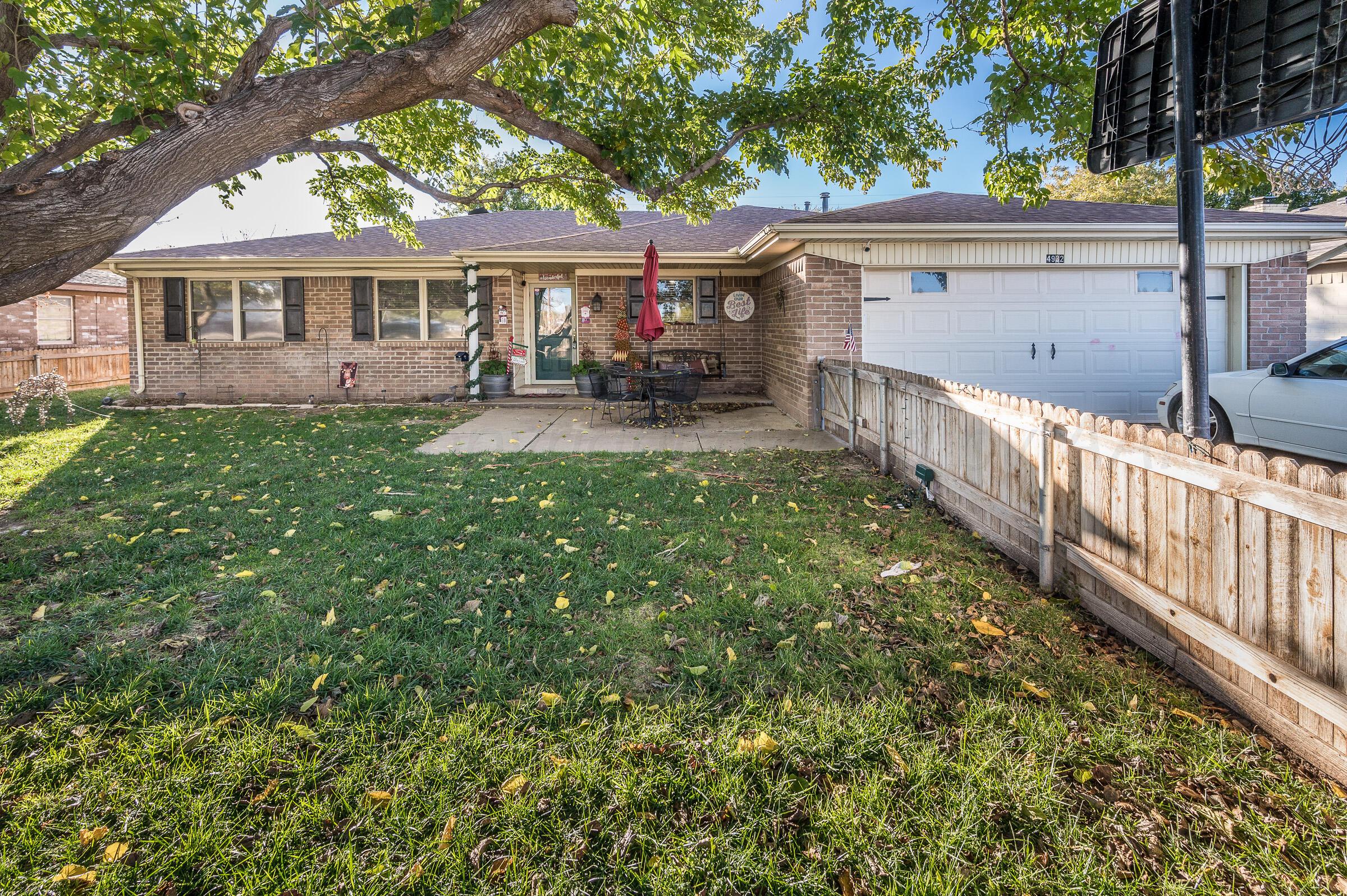 4932 South Georgia Street Amarillo, TX 79110 - Photo 1 of 23 a view of a house with backyard and sitting area