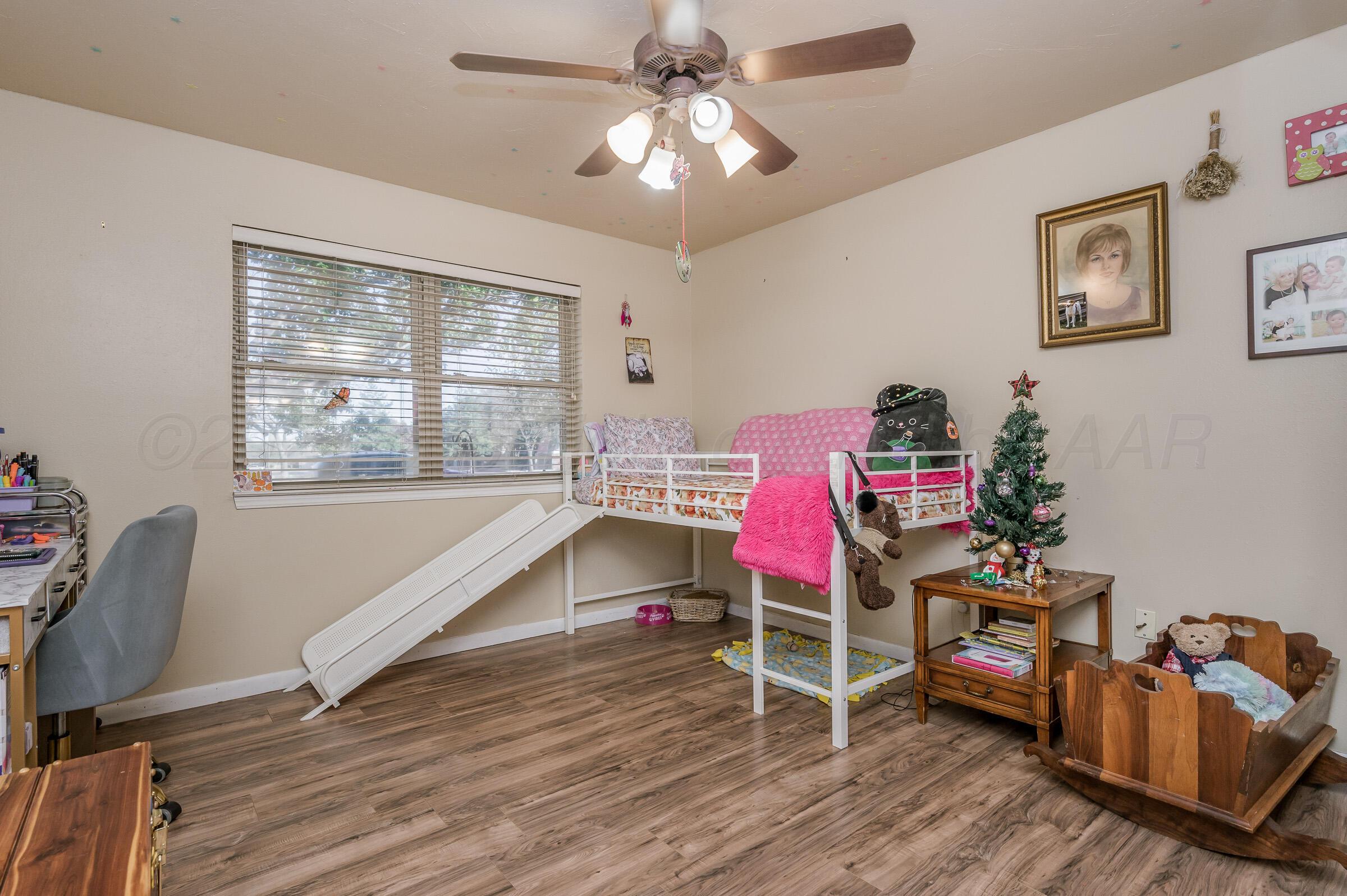 4932 South Georgia Street Amarillo, TX 79110 - Photo 16 of 23 a room with furniture and a wooden floor