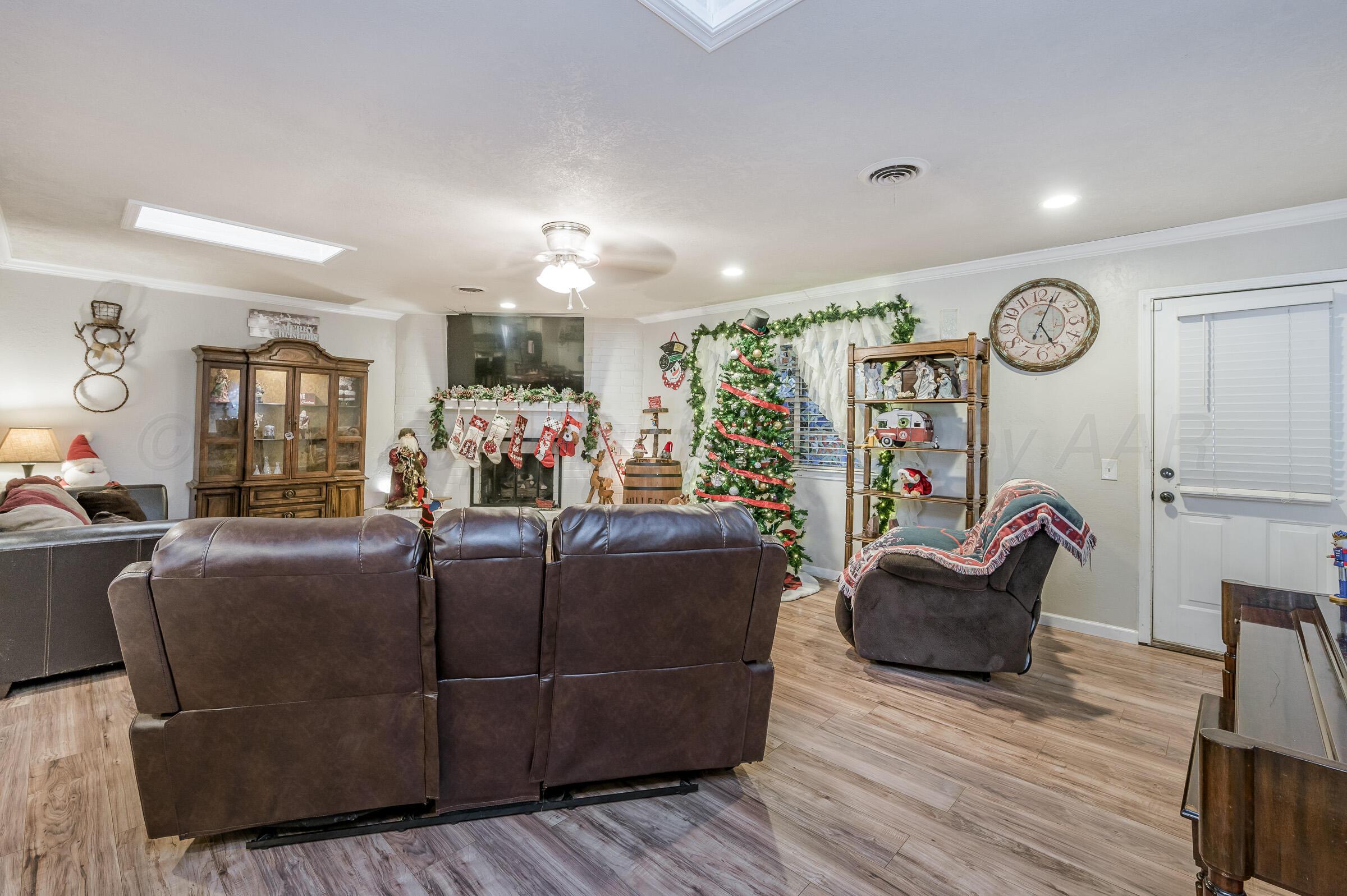 4932 South Georgia Street Amarillo, TX 79110 - Photo 4 of 23 a living room with furniture and a wooden floor