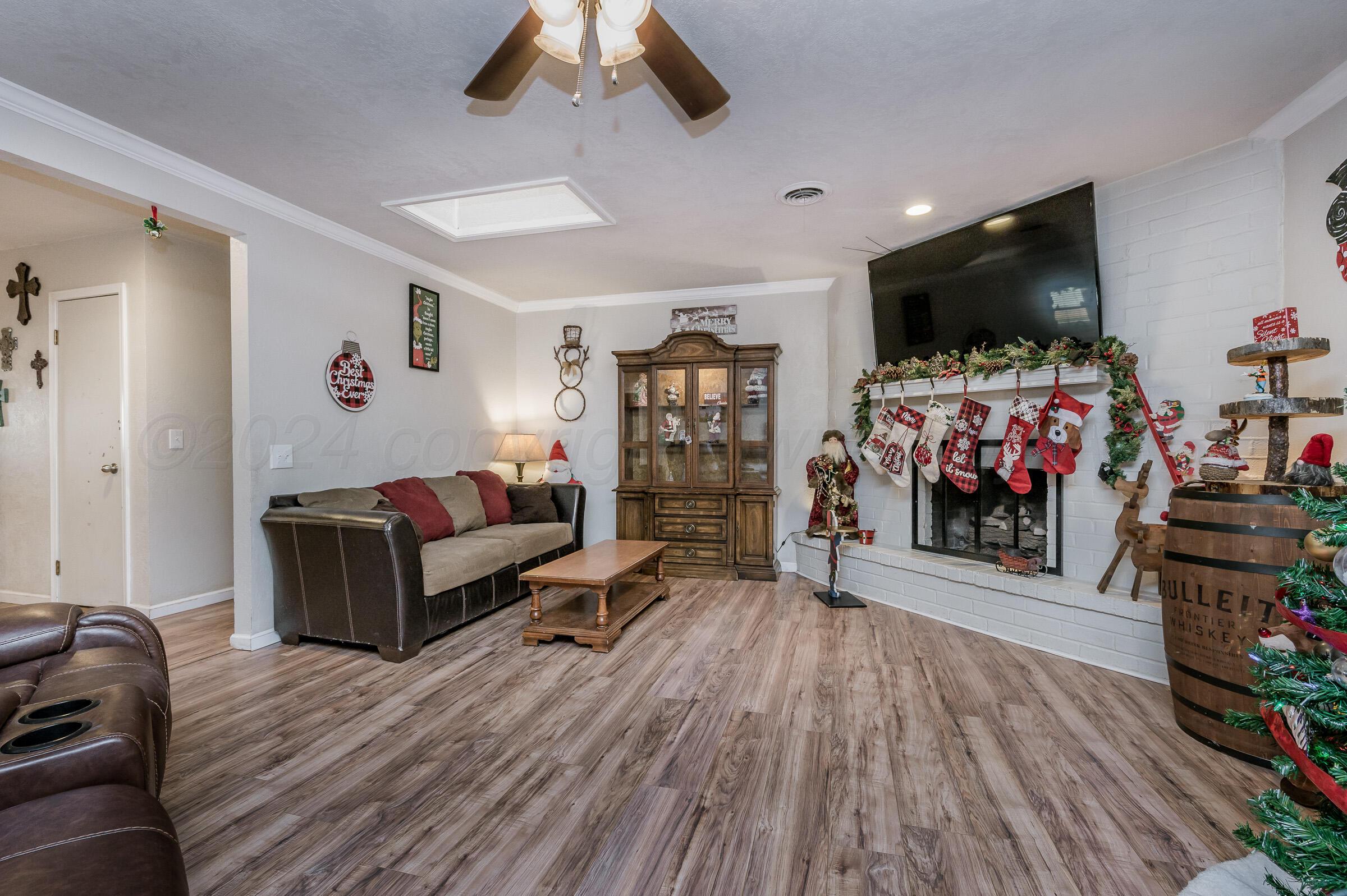 4932 South Georgia Street Amarillo, TX 79110 - Photo 5 of 23 a living room with furniture and a flat screen tv
