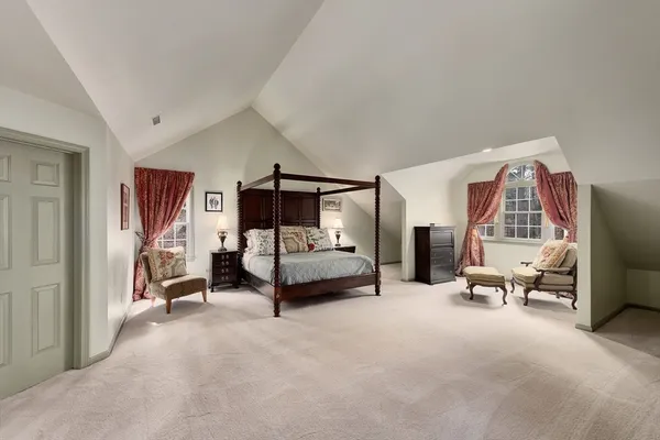 a bedroom with furniture and a large window
