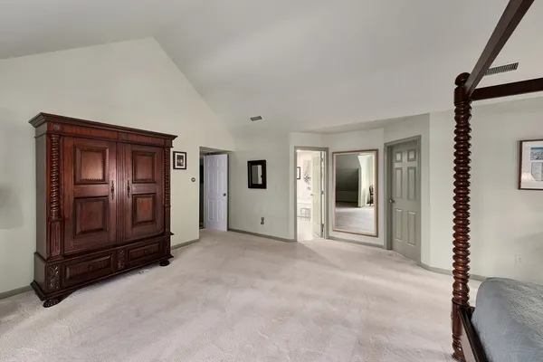 a view of an empty room with glass door and windows