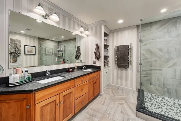 a spacious bathroom with double vanity sink and a shower