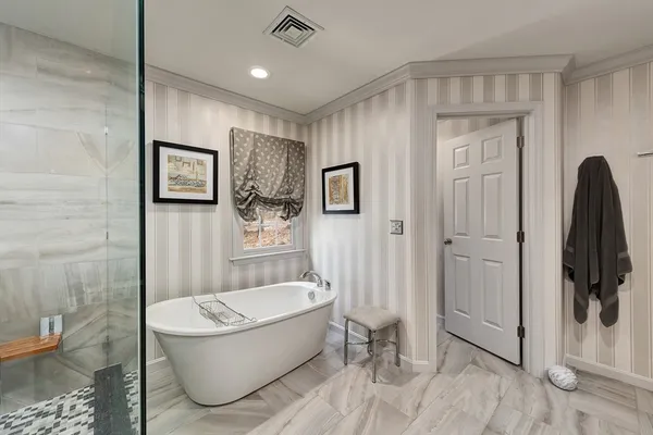a bathroom with a tub a toilet and a shower