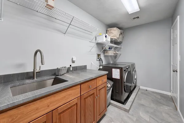 a kitchen with a sink and chandelier