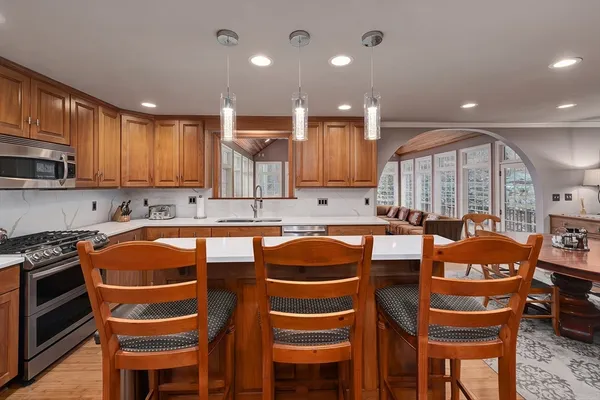 a kitchen with stainless steel appliances granite countertop a stove a sink and a refrigerator
