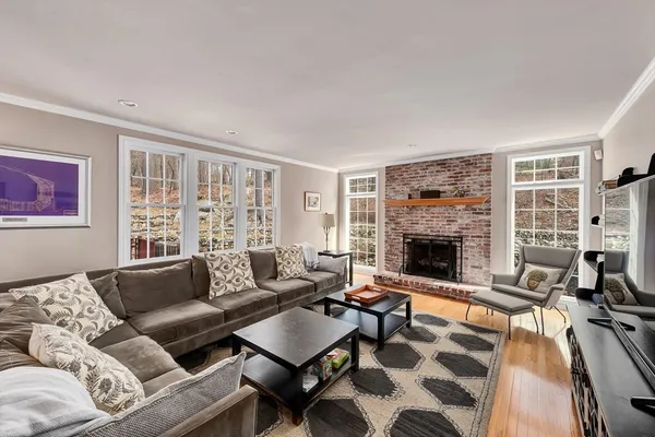 a living room with furniture a flat screen tv and a fireplace