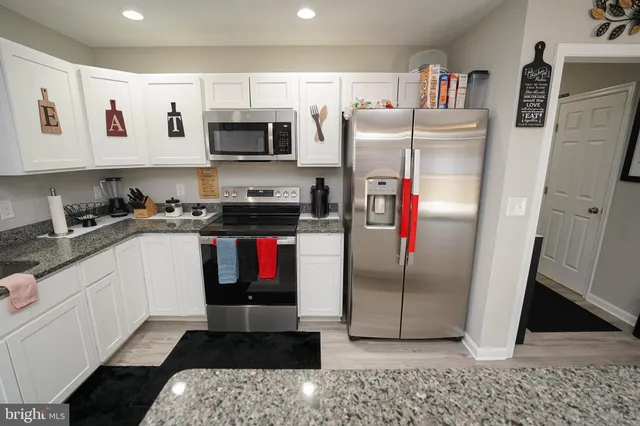 a kitchen with refrigerator and window