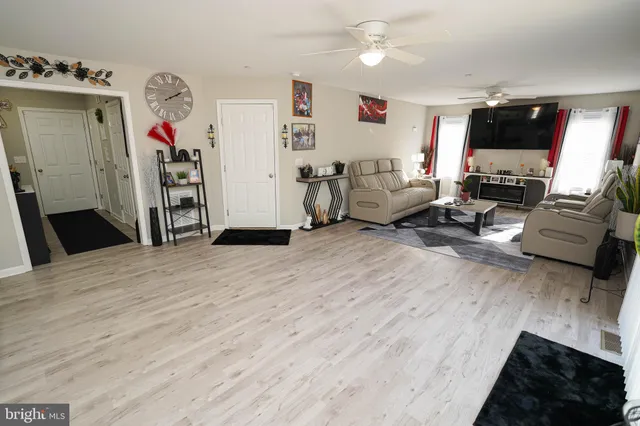 a view of a livingroom with workspace and a couch