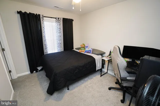 a bedroom with a bed and flat screen tv