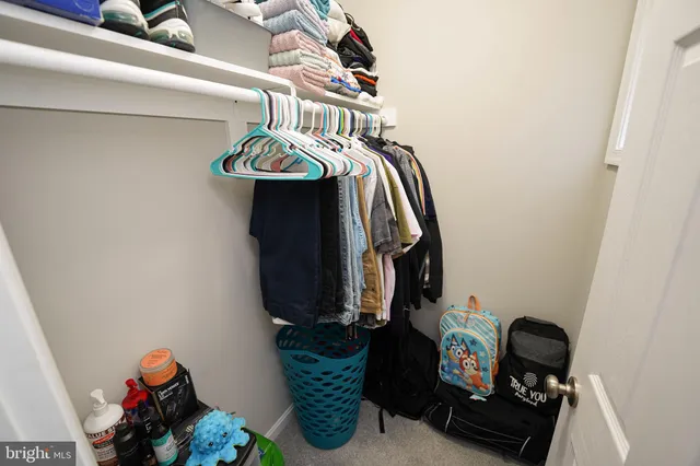 a spacious bedroom with a bed and a window