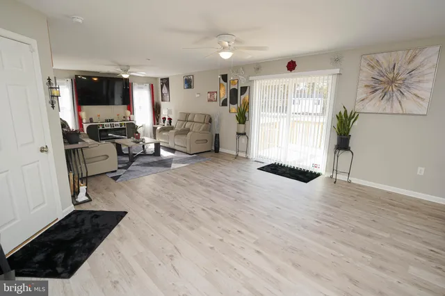 a view of a livingroom with furniture and a flat screen tv