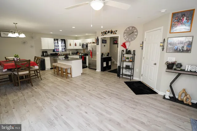 a kitchen with a refrigerator and a stove top oven