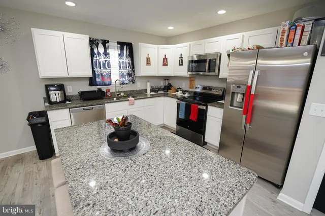 a kitchen with a refrigerator and a sink
