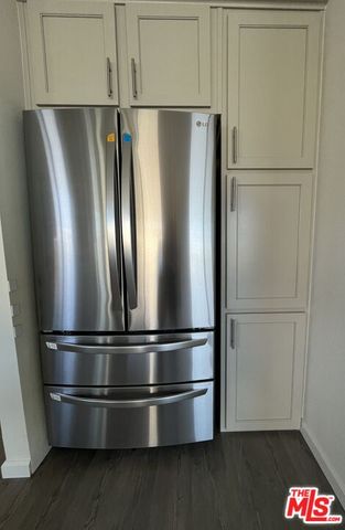 a bedroom with a bed and a mirror