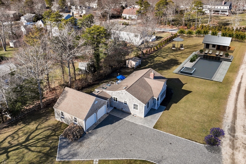 an aerial view of a house with a yard and parking spaces