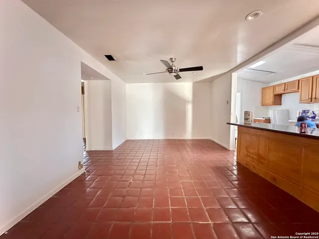a view of empty room with wooden floor and window