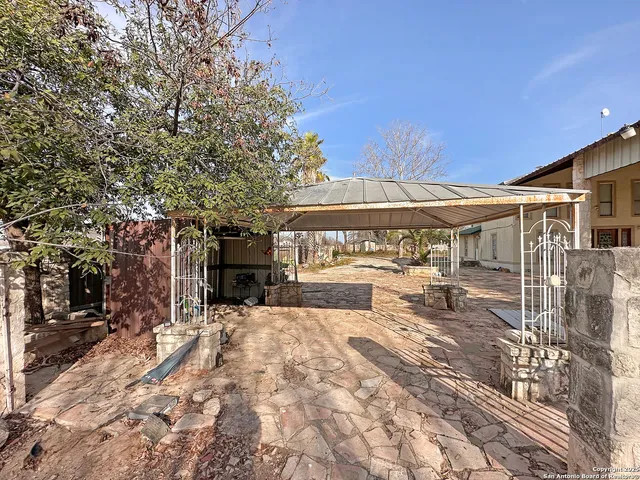 a view of green field with house in the background