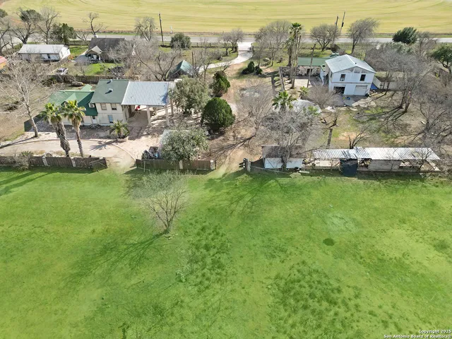 a view of yard with swimming pool and green space