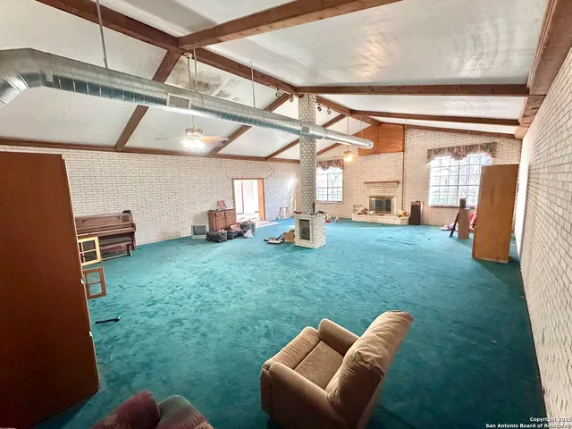 a backyard of a house with wooden floor and furniture