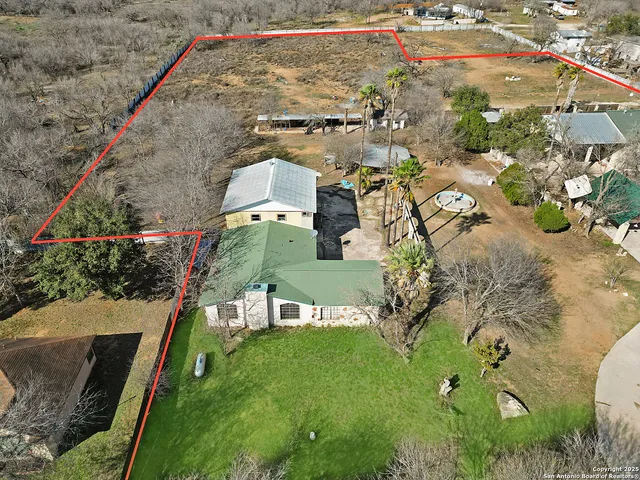 an aerial view of a house with a yard