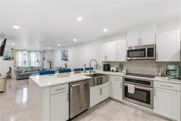 a kitchen with a sink stove and cabinets