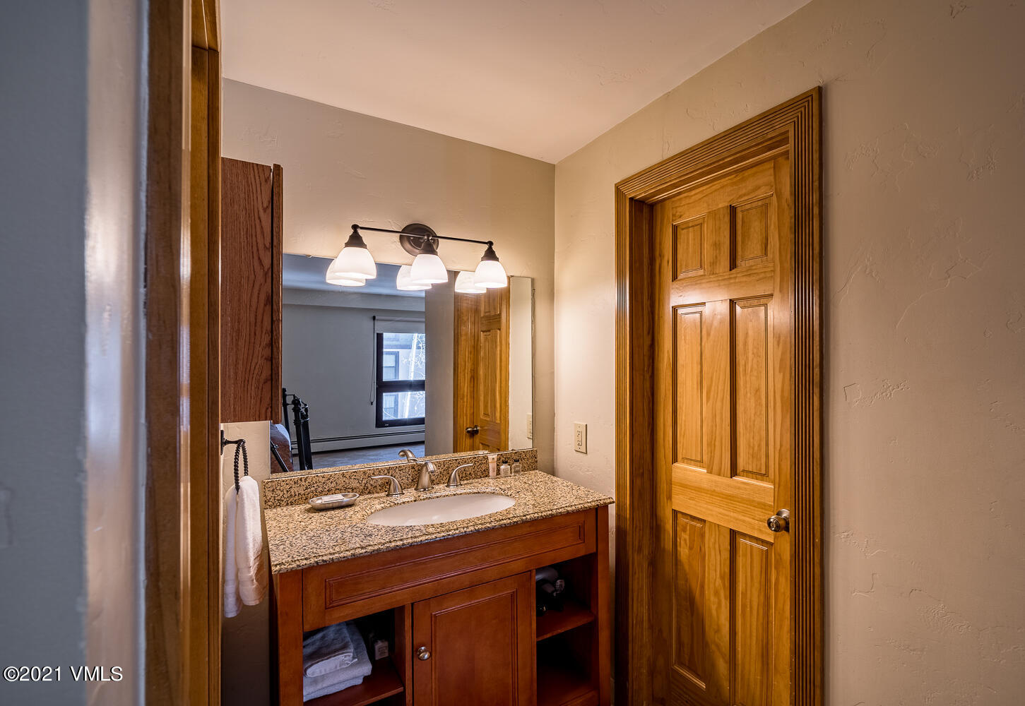 993 Lions Ridge Loop, Unit 331 Vail, CO 81657 - Photo 13 of 20 a bathroom with a granite countertop sink and a mirror