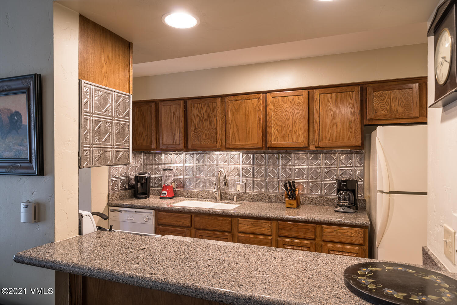 993 Lions Ridge Loop, Unit 331 Vail, CO 81657 - Photo 6 of 20 a kitchen with stainless steel appliances granite countertop a sink refrigerator and cabinets