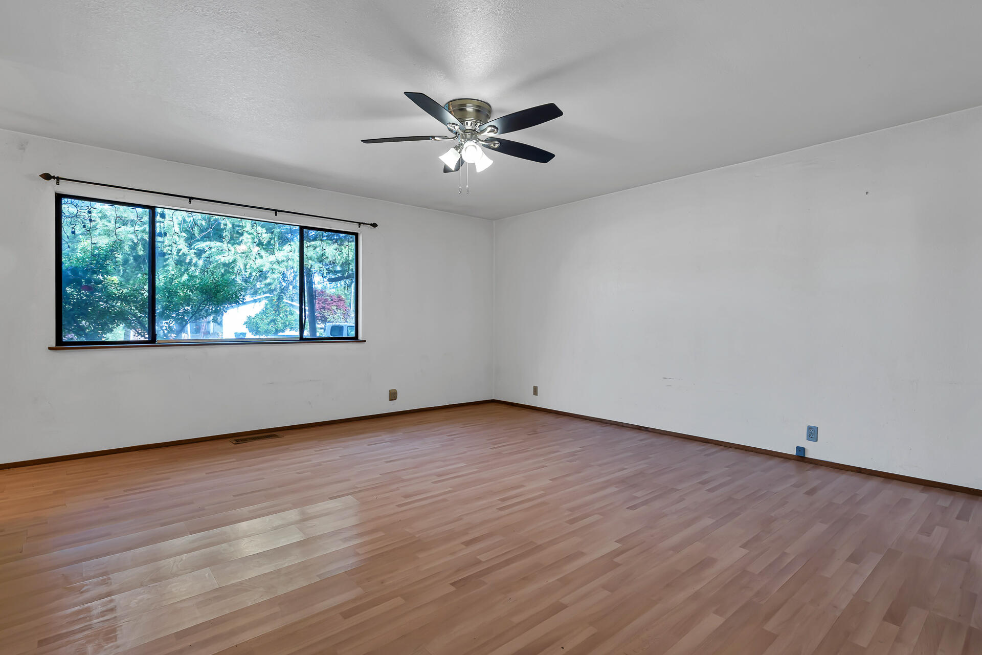 240 D Street Tehama, CA 96090 - Photo 15 of 41 an empty room with wooden floor chandelier fan and windows
