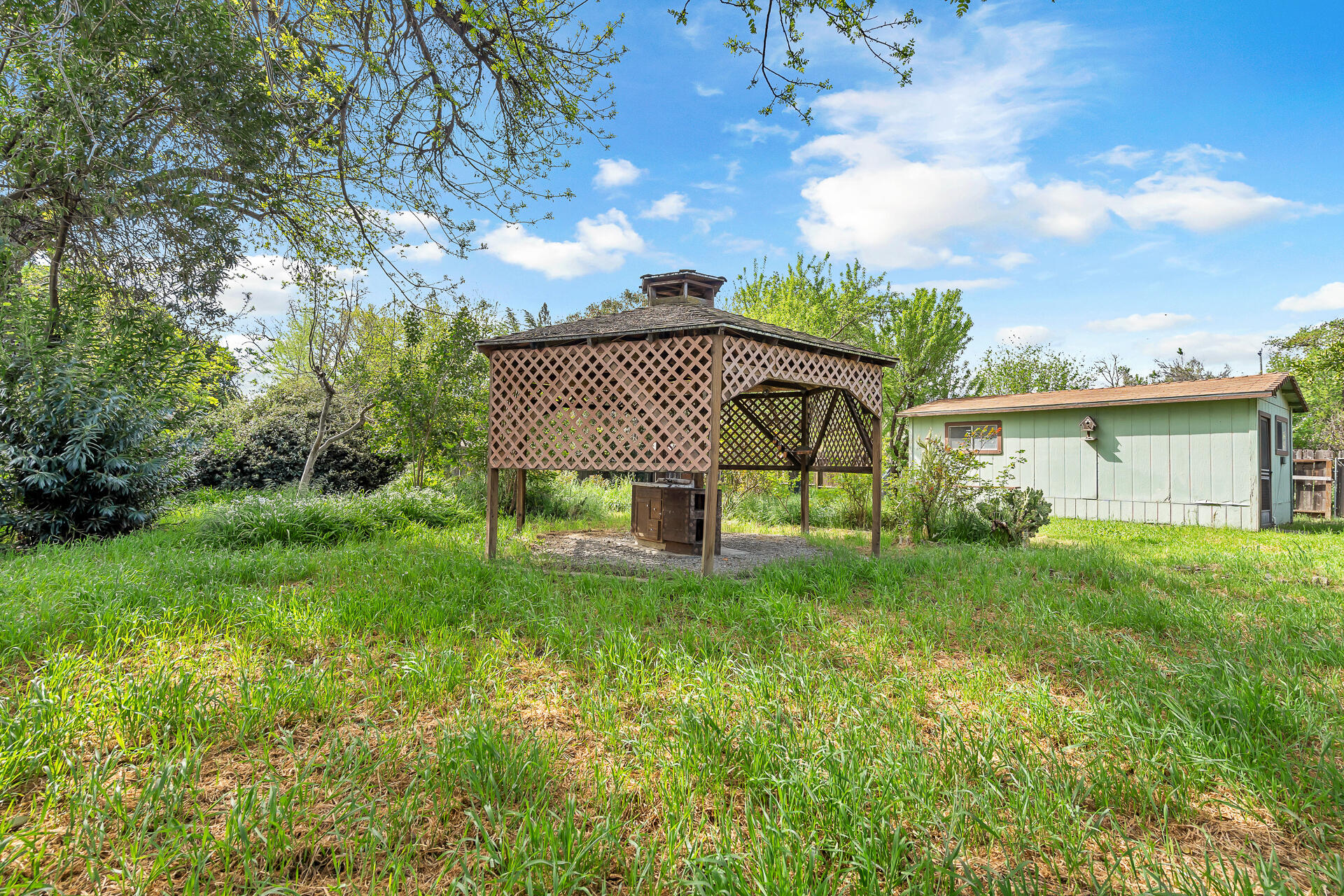 240 D Street Tehama, CA 96090 - Photo 31 of 41 a view of a house with a backyard and a garden